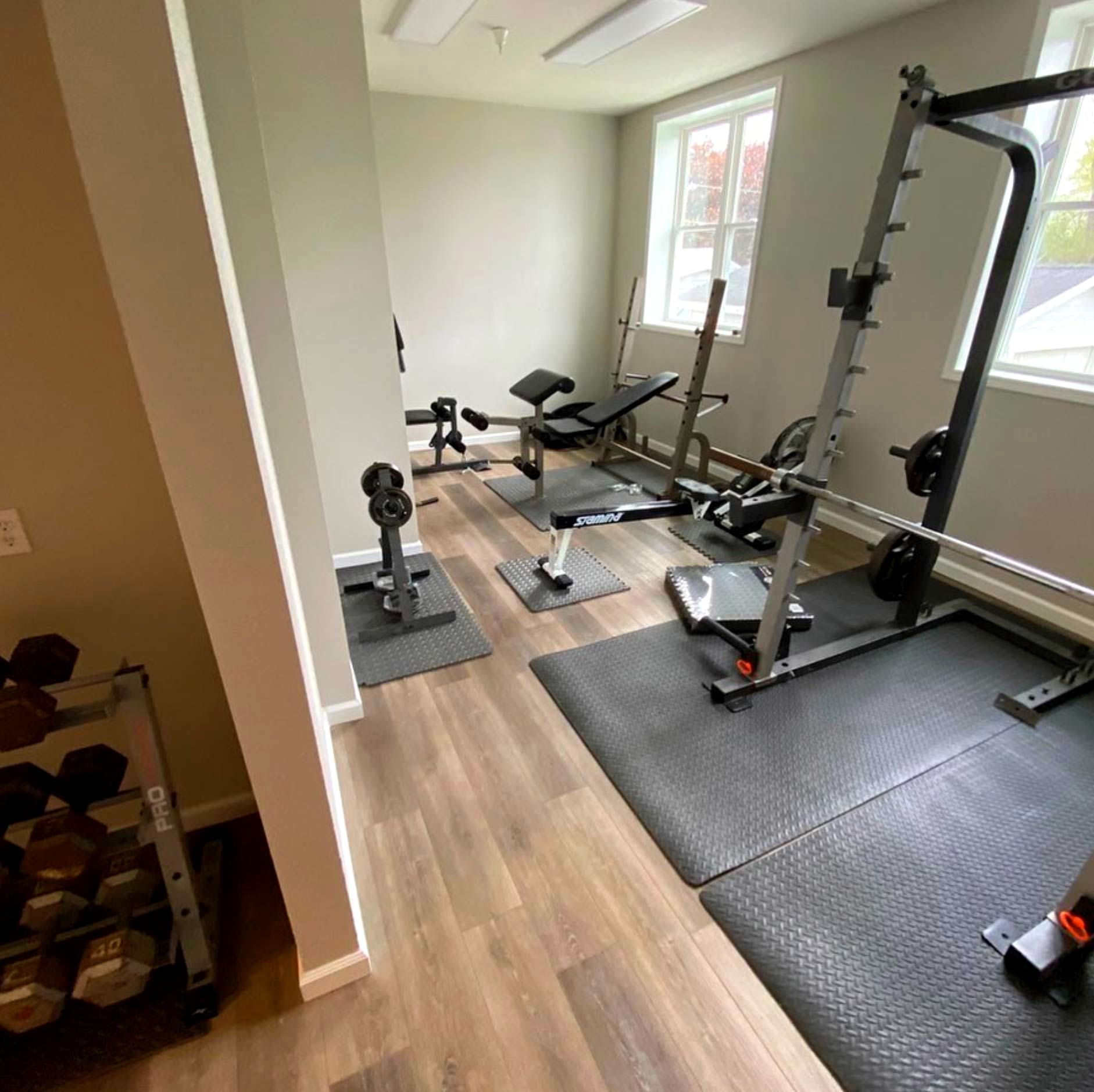 A gym with a lot of exercise equipment in it