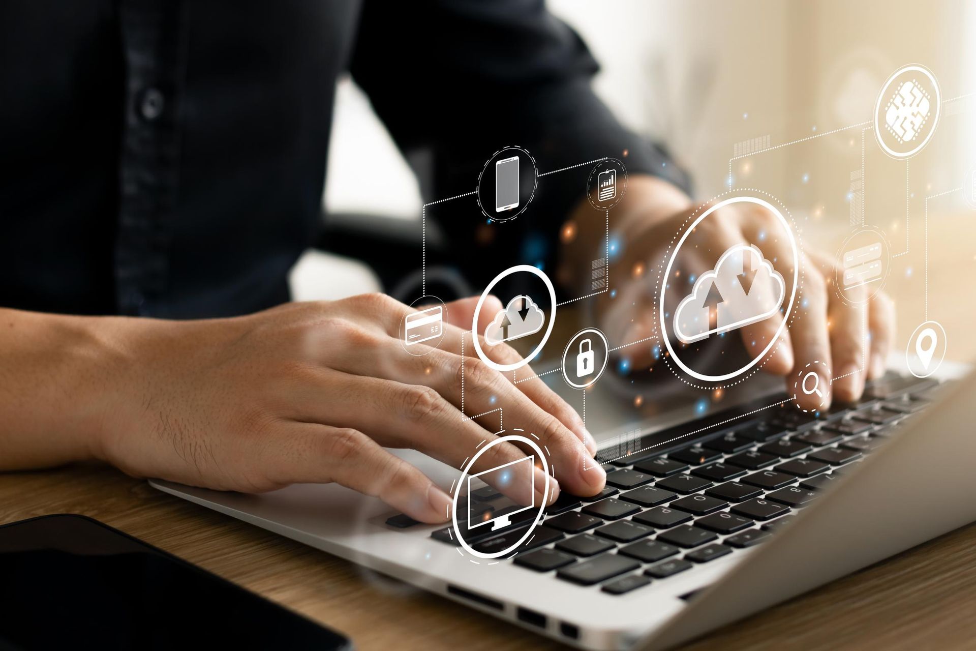 Person using laptop with digital cloud and data icons overlayed.