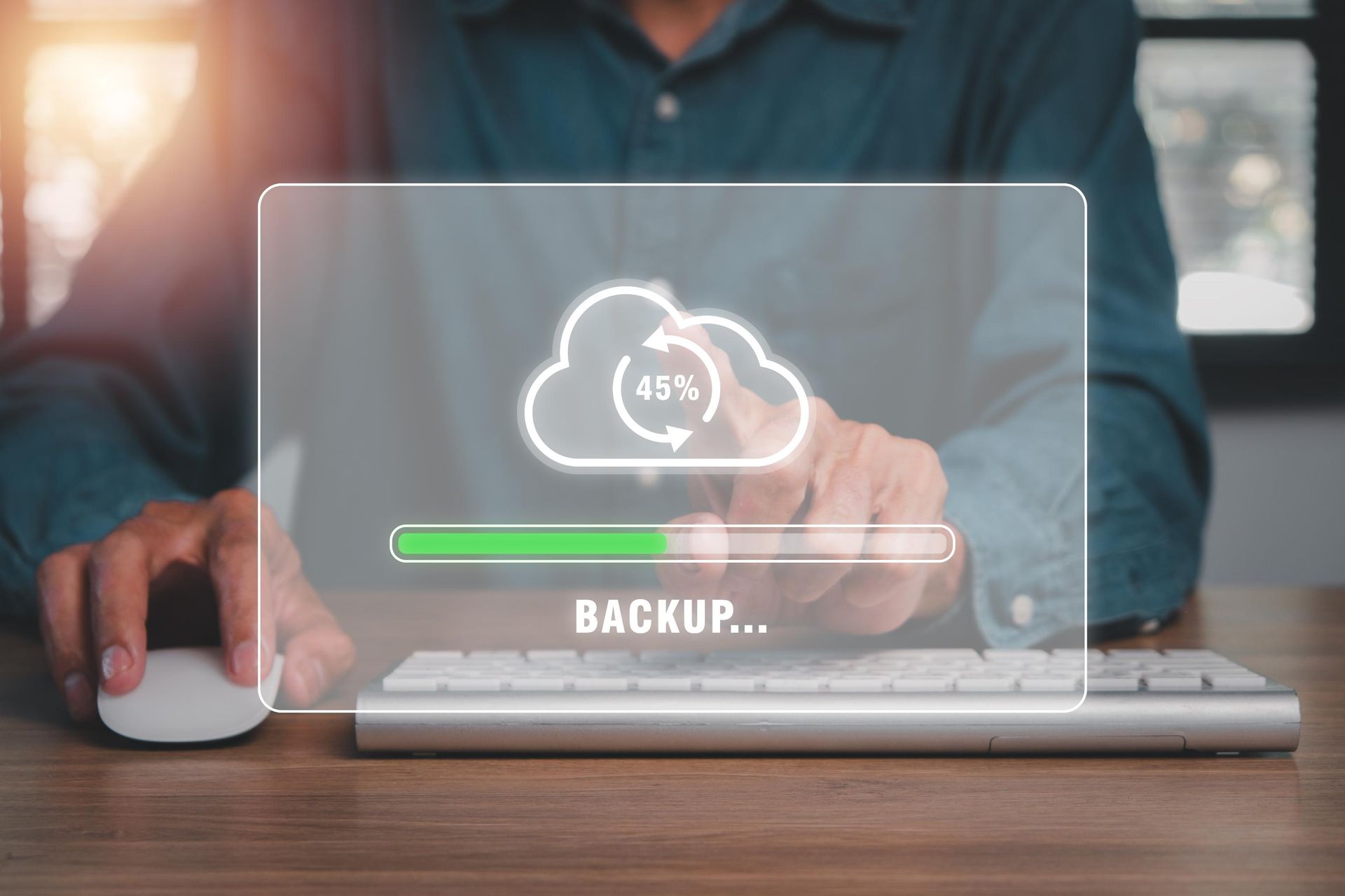 Person using a computer, with a cloud backup progress bar at 45%.