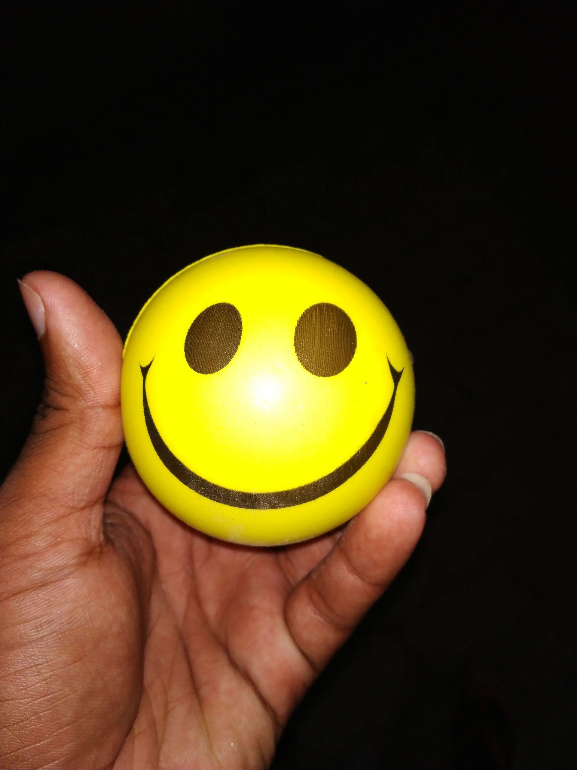 hand holding a smiley face
