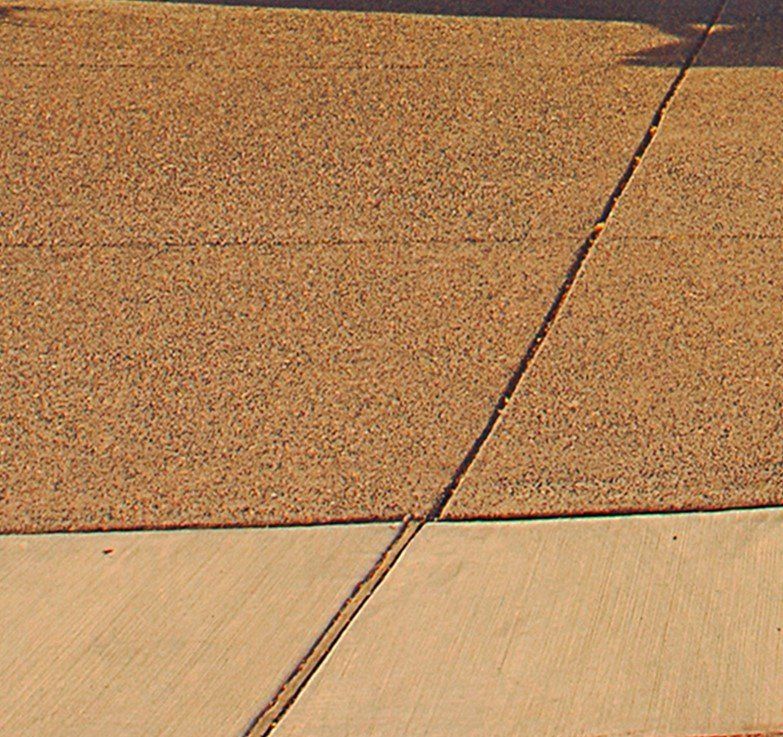 Residential walkway in multi-coloured concrete with blue, yellow, green, and brown in Cranbourne VIC.