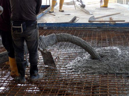 Team of concreters constructing building's flooring and completing a commercial concrete project in Cranbourne VIC.