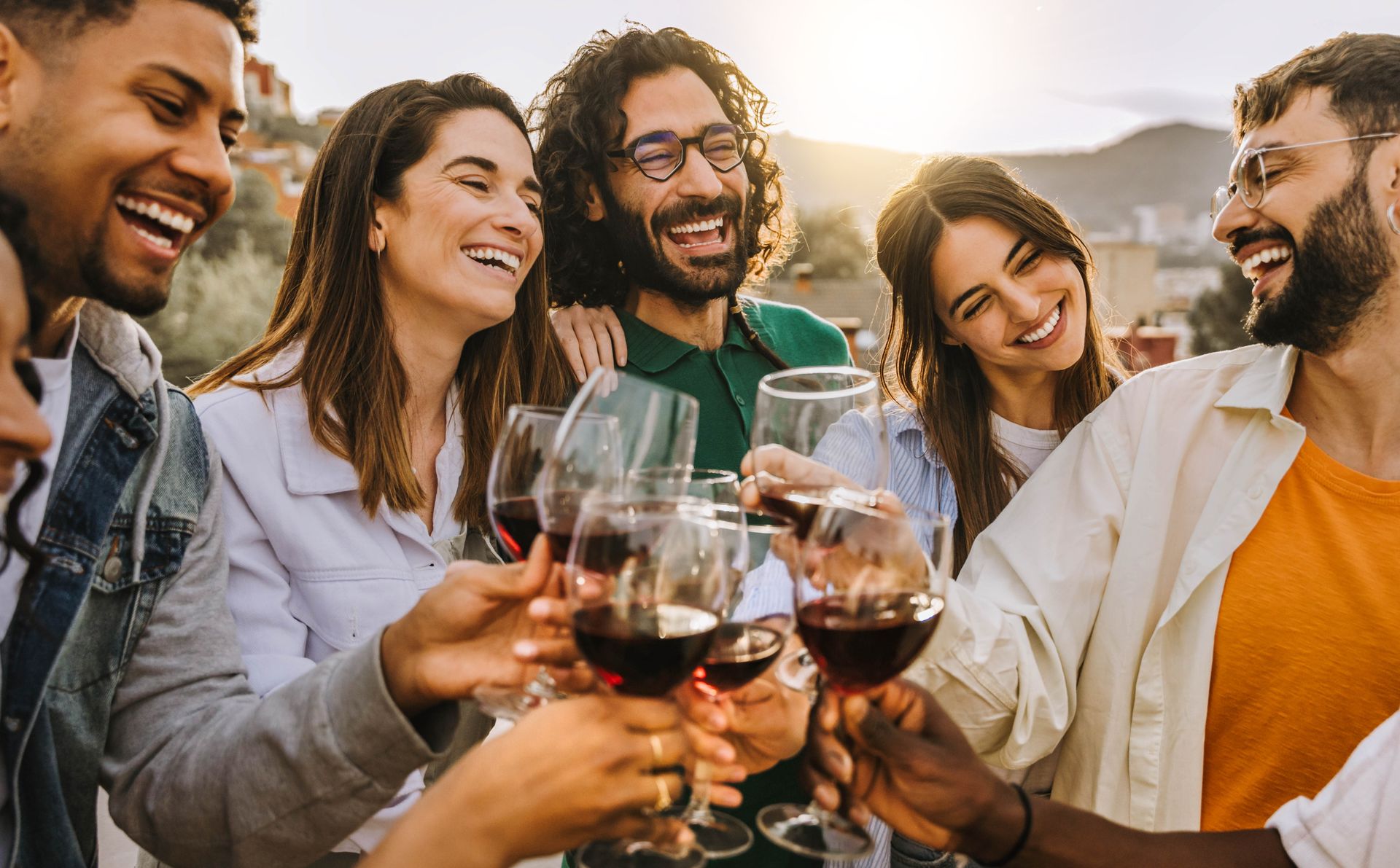 A group of people are toasting with wine glasses at a party.