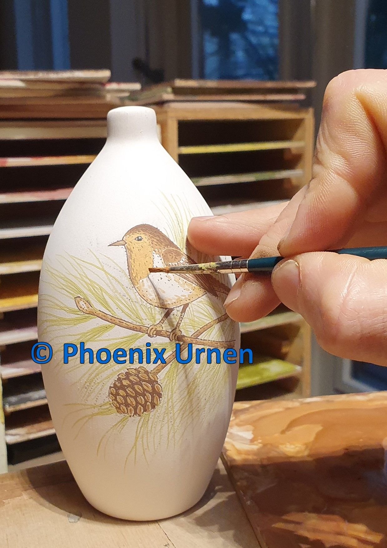 Painting process urn Robin on pine branch