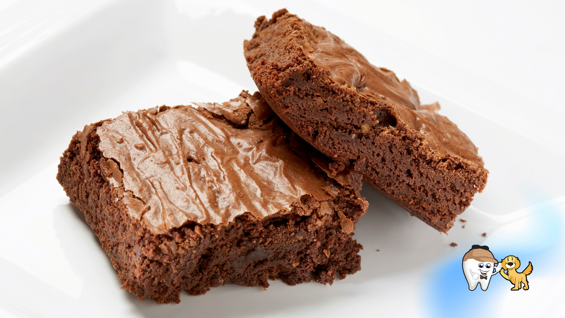 Two chocolate brownies on a white plate; one whole, one sliced.
