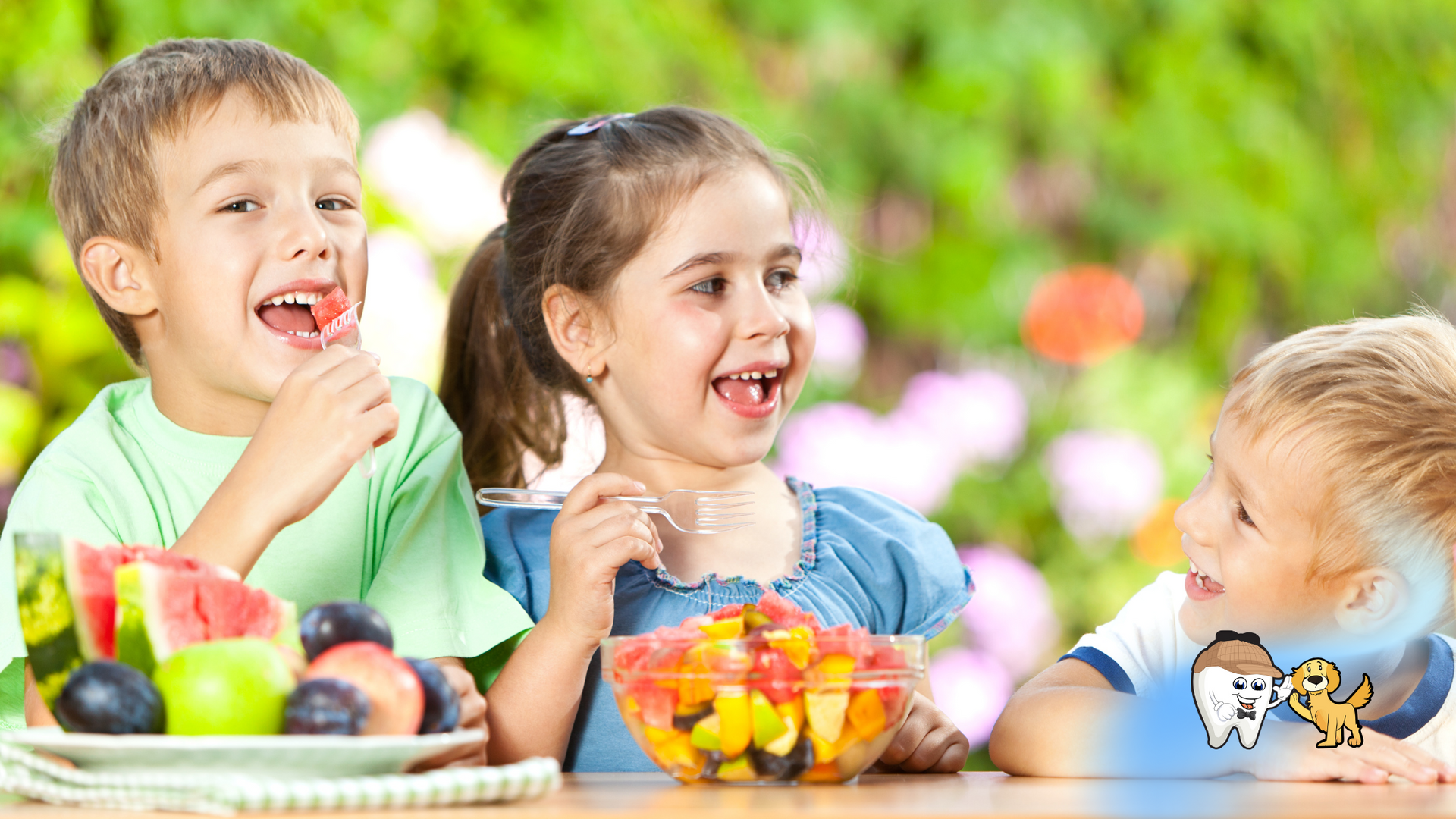 A group of children are sitting at a table eating fruit.