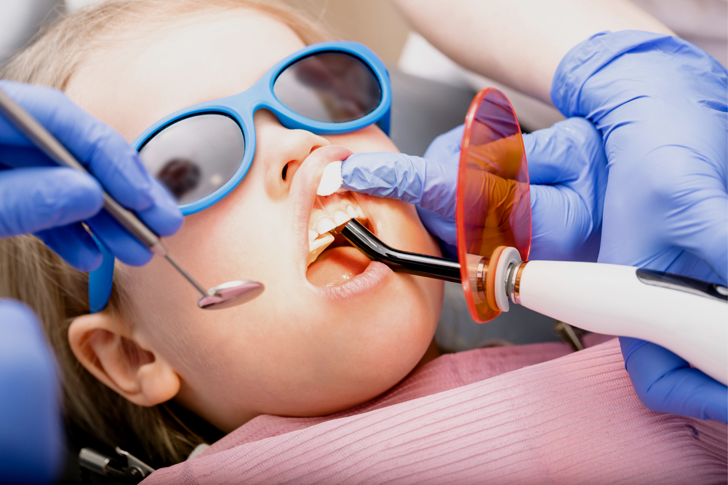 Dentist examining a woman with cheek pain in a clinic, gloved hand touching her face