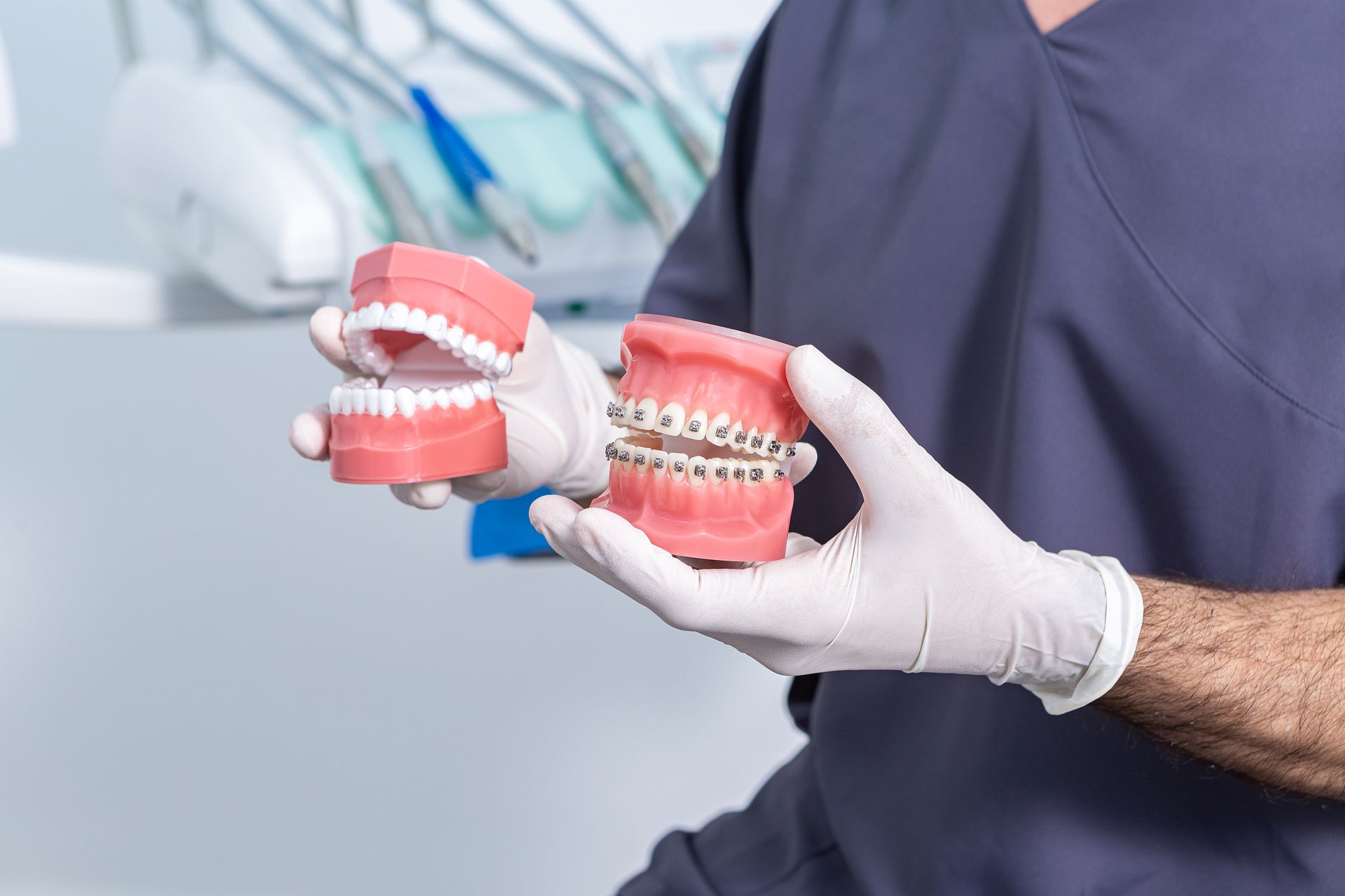 orthodontist holding model of mouth