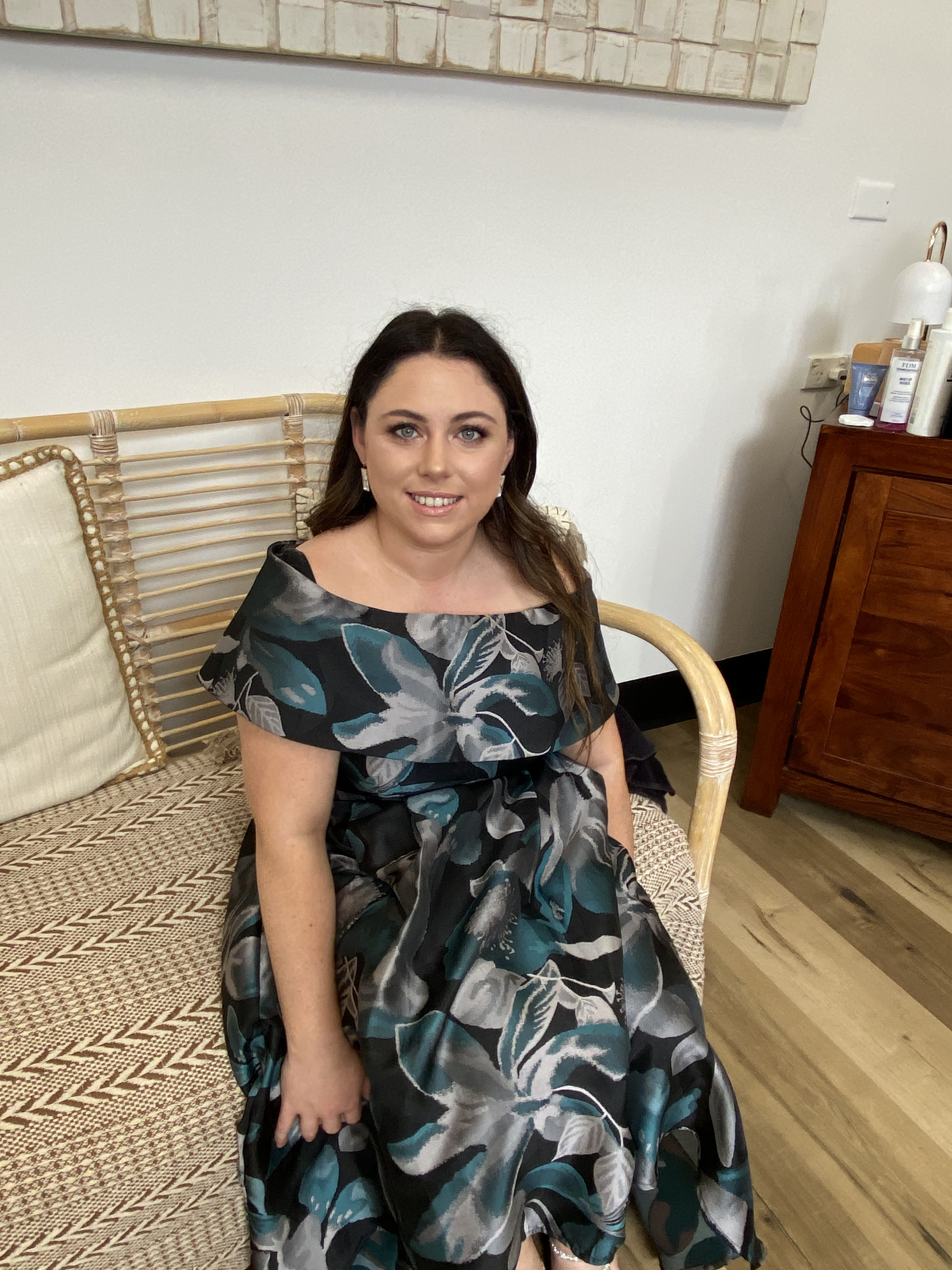 Blonde Woman With Wavy Hair Wearing A Black Top And A Necklace — Penelope's Beauty in Newcastle, NSW