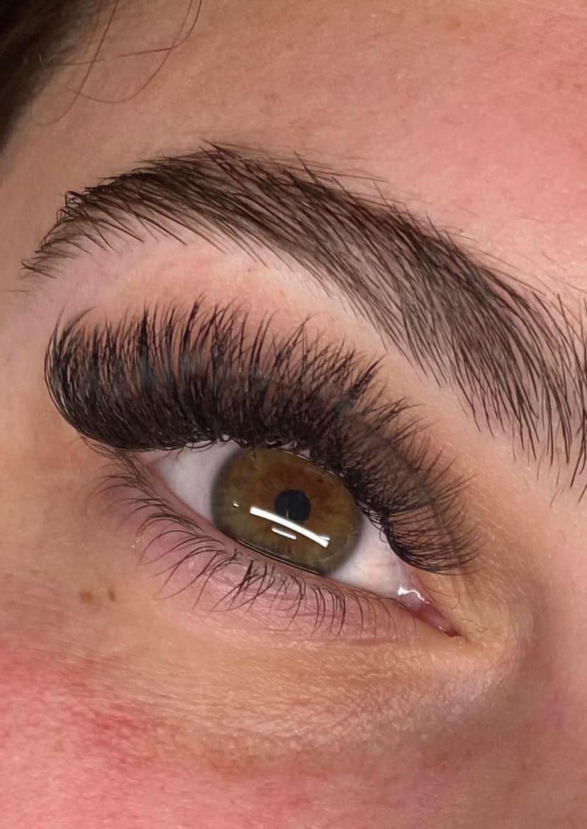 Woman With Long Eyelashes And Light Makeup Looking At The Camera In A Salon — Penelope's Beauty in Newcastle, NSW