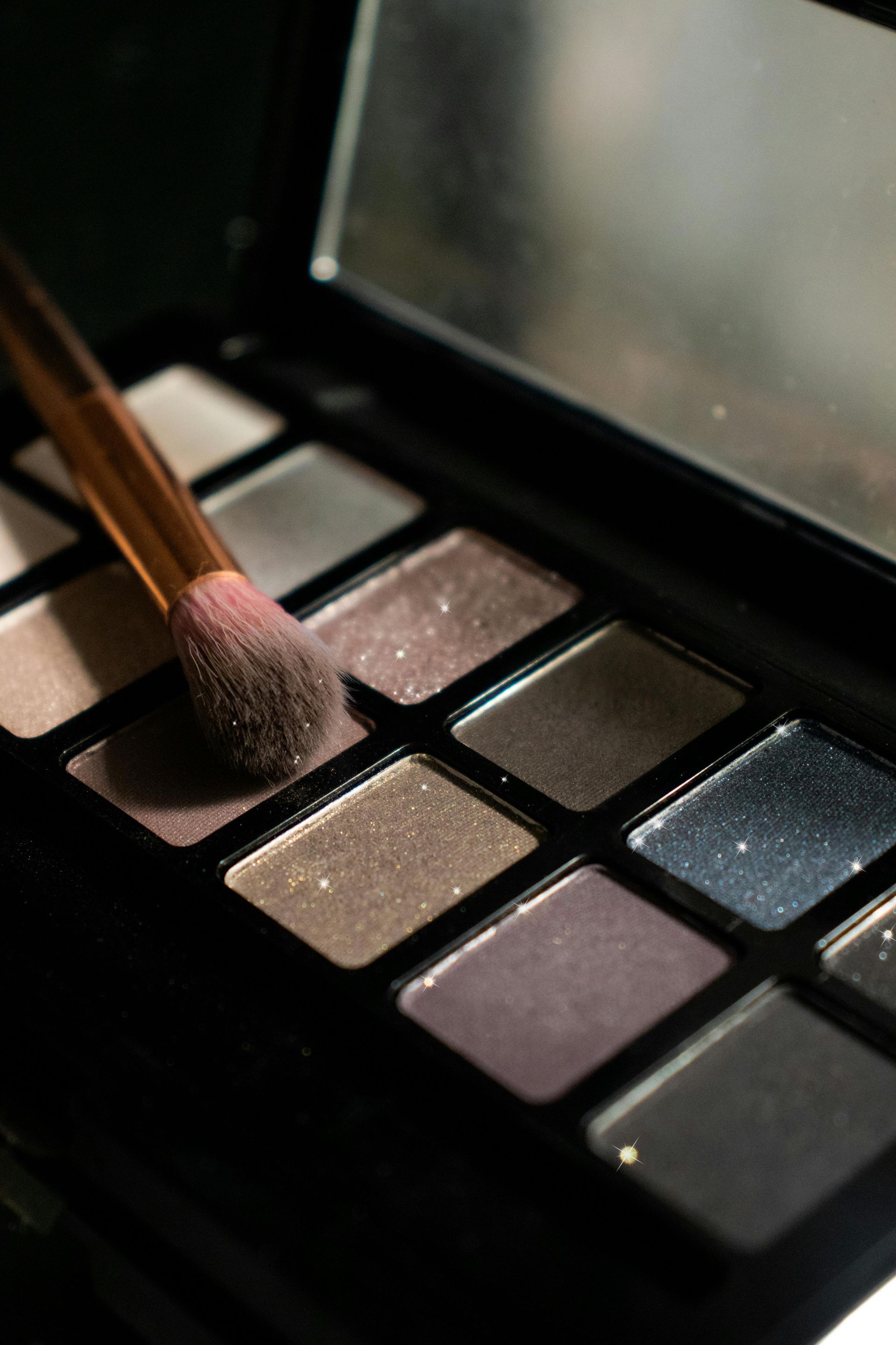 Eyeshadow Palette With A Brush Resting On A Neutral Shade — Penelope's Beauty in Raymond Terrace, NSW