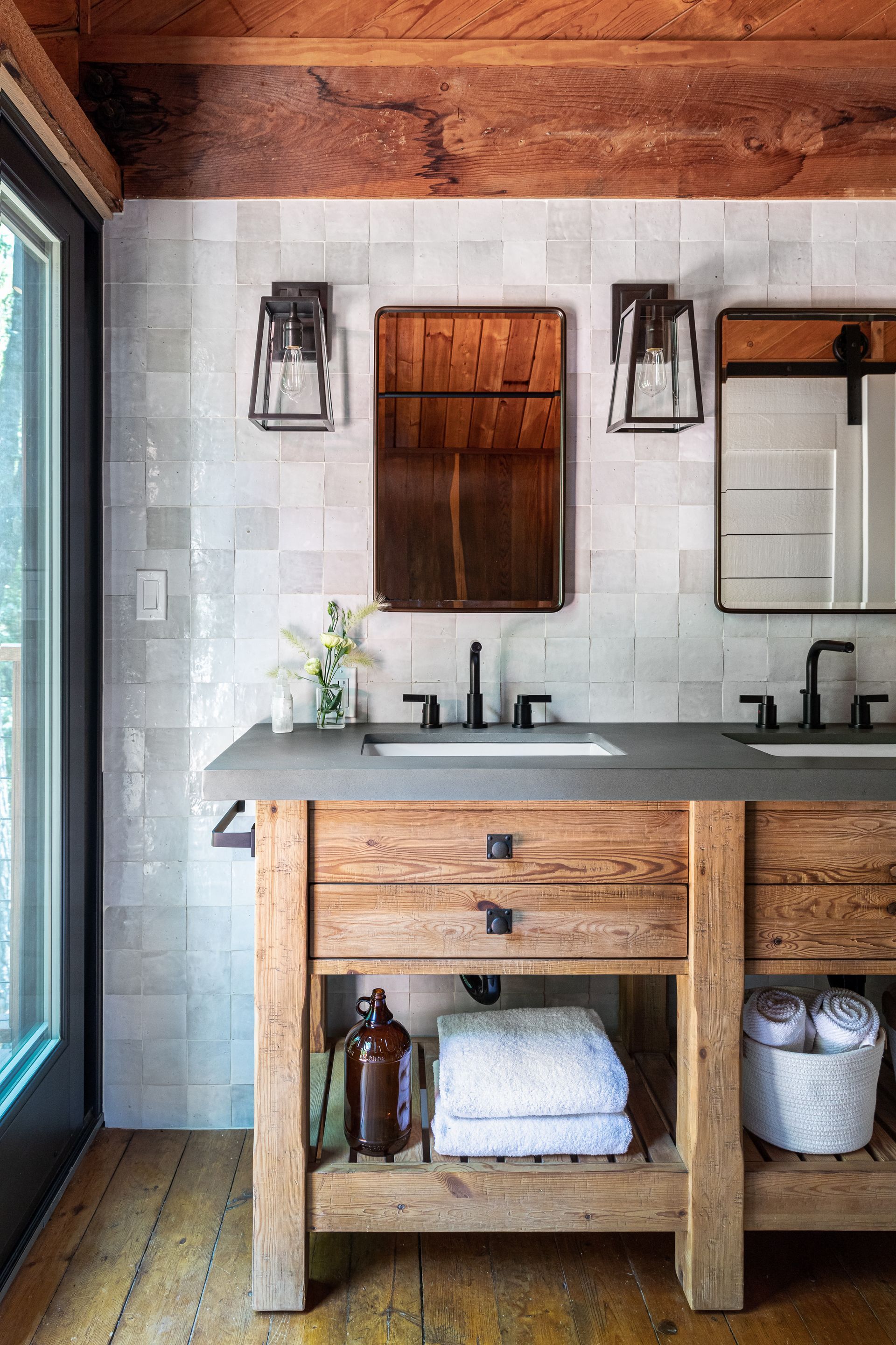 A bathroom with two sinks and two mirrors.