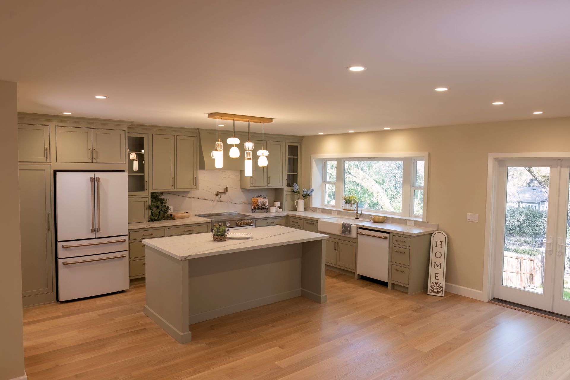 Modern kitchen with a center island and large windows in an Auburn, California custom home