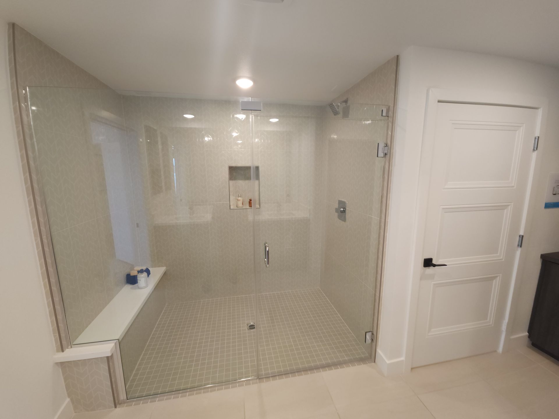 White-tiled bathroom wet room with a walk-in shower