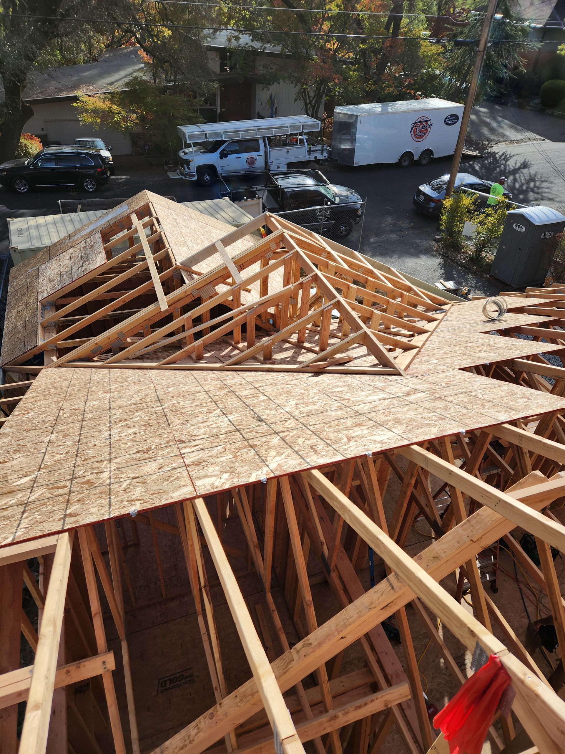 Aerial view of roof framing and rafters during a home addition