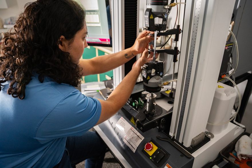 a woman is working on a machine in a lab a woman is working on a machine in a lab
