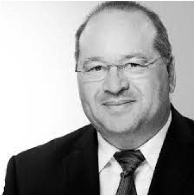 A black and white photo of a man in a suit and tie.