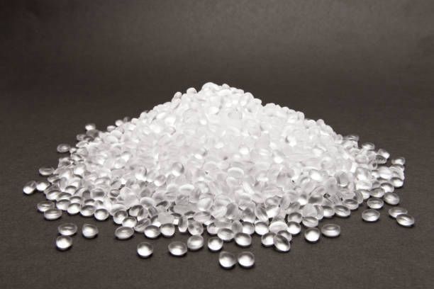 plastic pellets held by gloved person plastic pellets held by gloved person