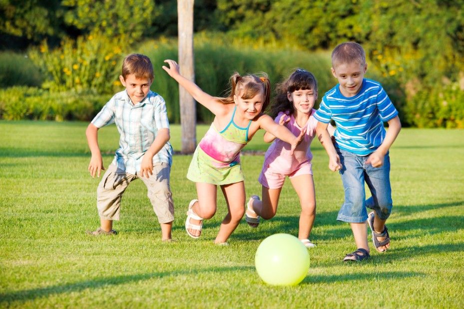 A Group of Children Are Playing With a Soccer Ball in a Park — Killarney Vale Preschool In Tumbi Umbi, NSW