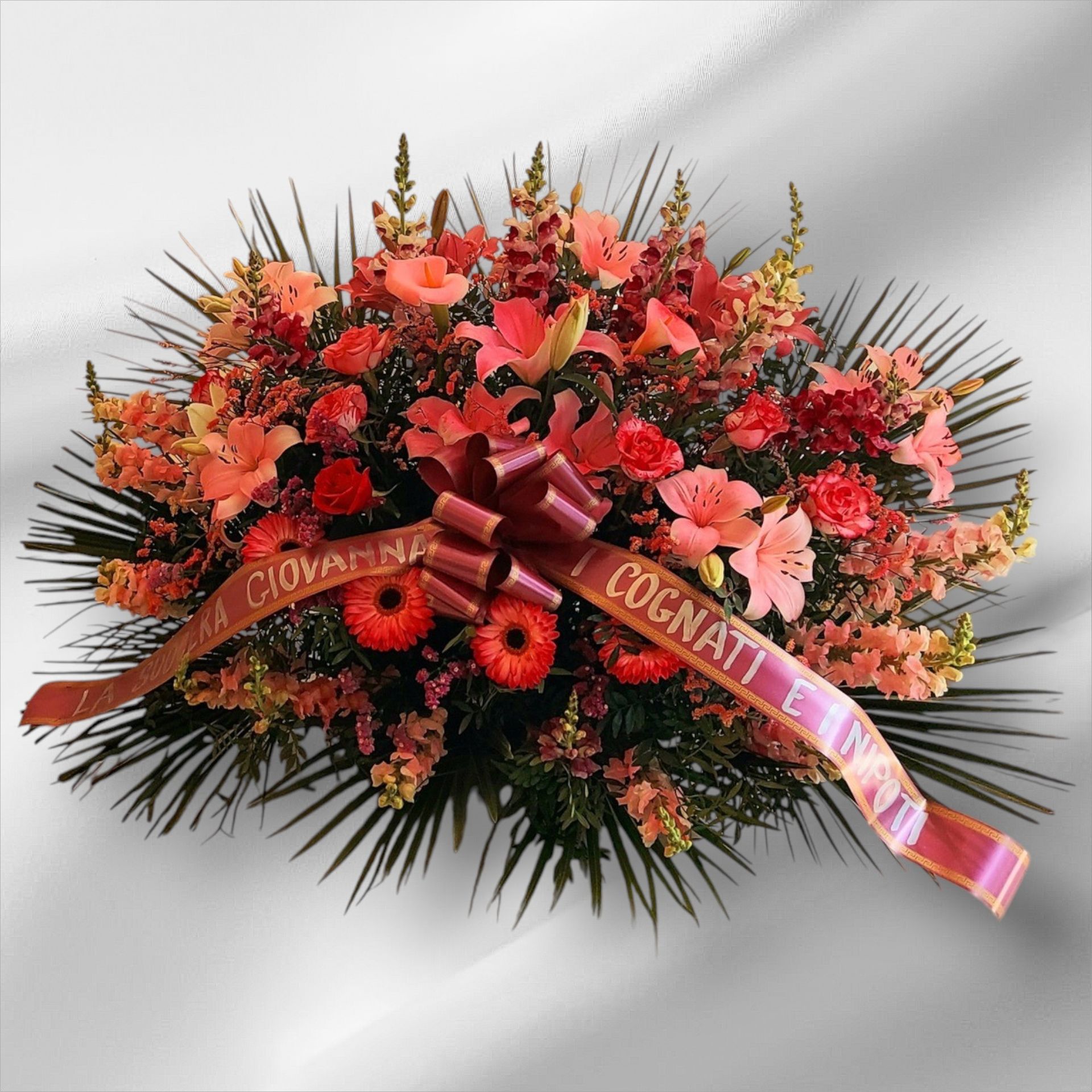 Floral funeral arrangement with pink, white, and yellow flowers and a ribbon reading “D. Stephen”