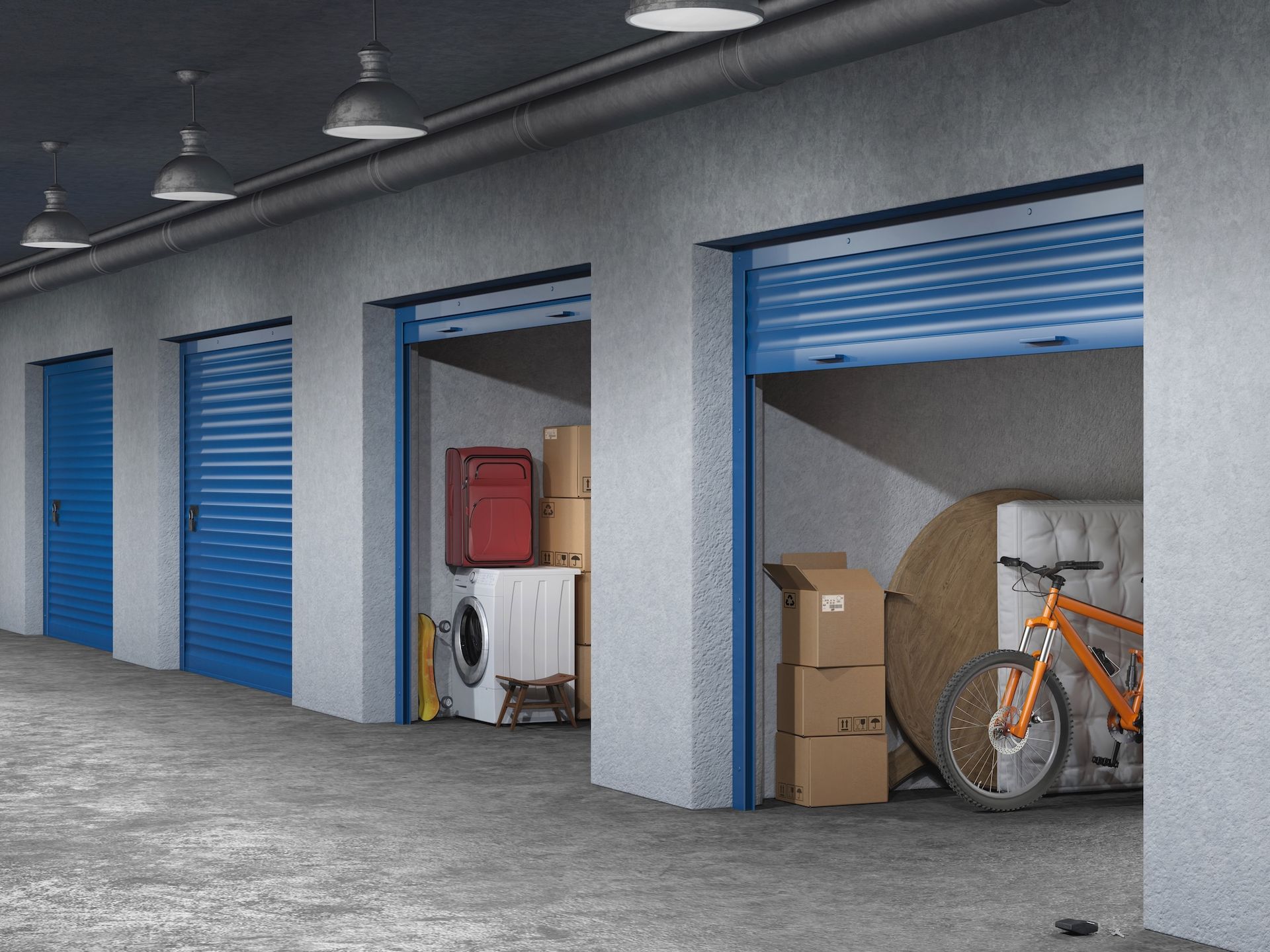 Storage units with blue roll-up doors, one open to boxes and an orange bicycle.