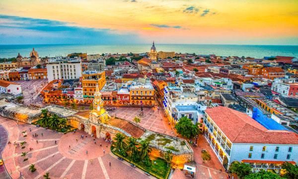 Aerial view of colourful historic Cartagena at sunset with tiled rooftops and a central square