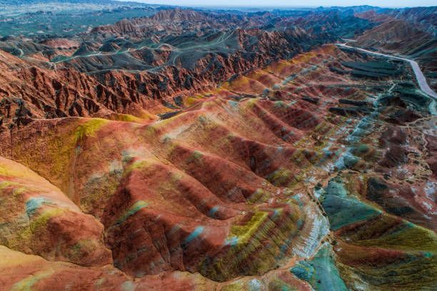 Zhangye Danxia, China Colorful striped canyon mountains with a winding river under a clear sky
