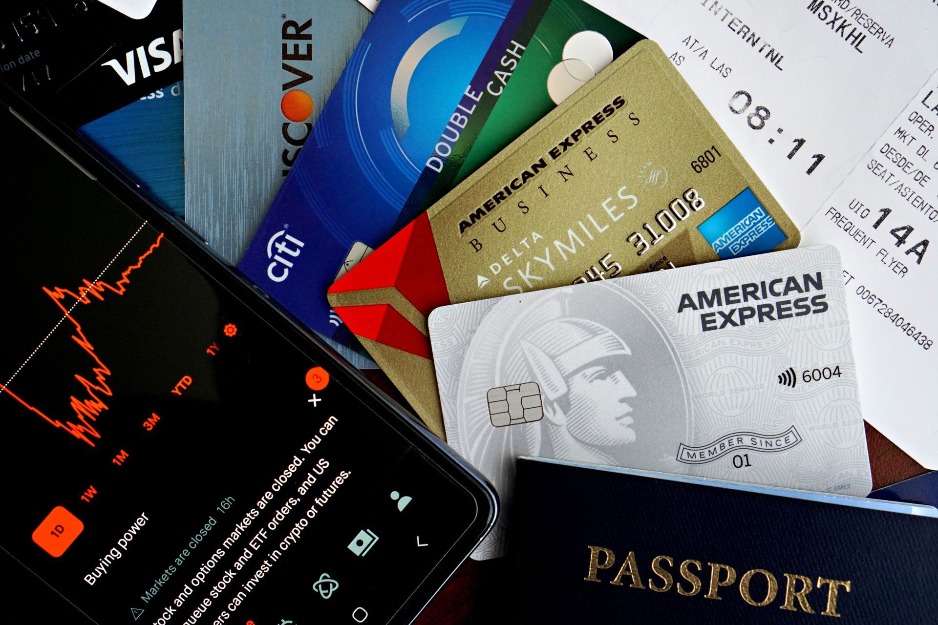 Passports, credit cards, and travel membership cards scattered on a table