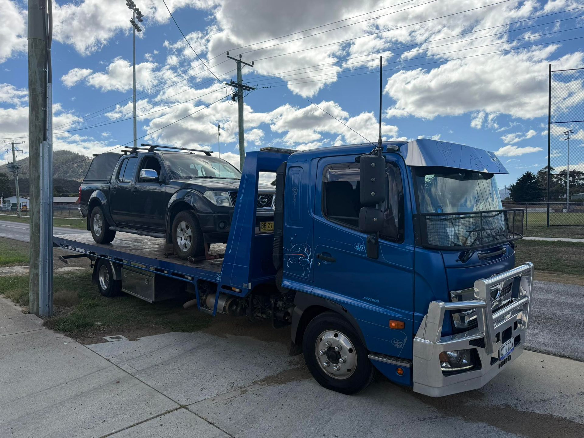 A Blue Flatbed Tow Truck Parked on a Paved Road — AAA ULTRA TOWING in Mornington, TAS