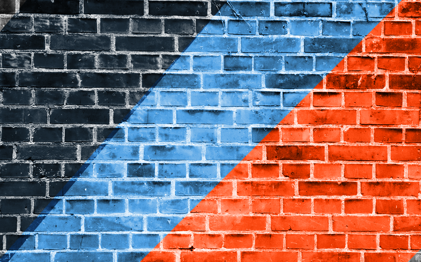 A brick wall with a blue and red stripe painted on it