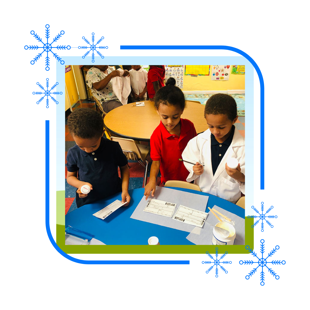 A group of children are sitting at a table in a classroom.