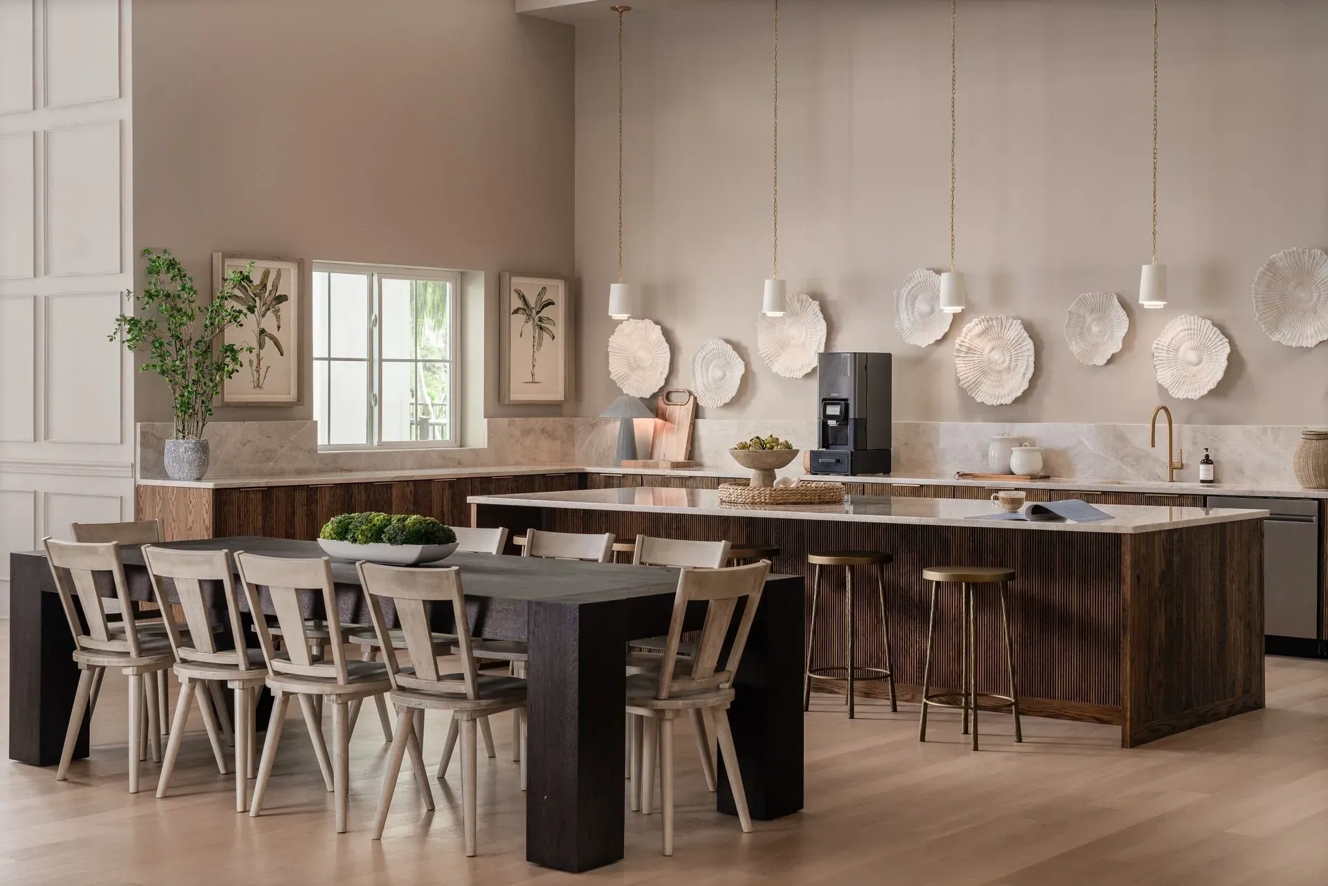 Kitchen and dining area in apartment community building, with coffee station and island bar.