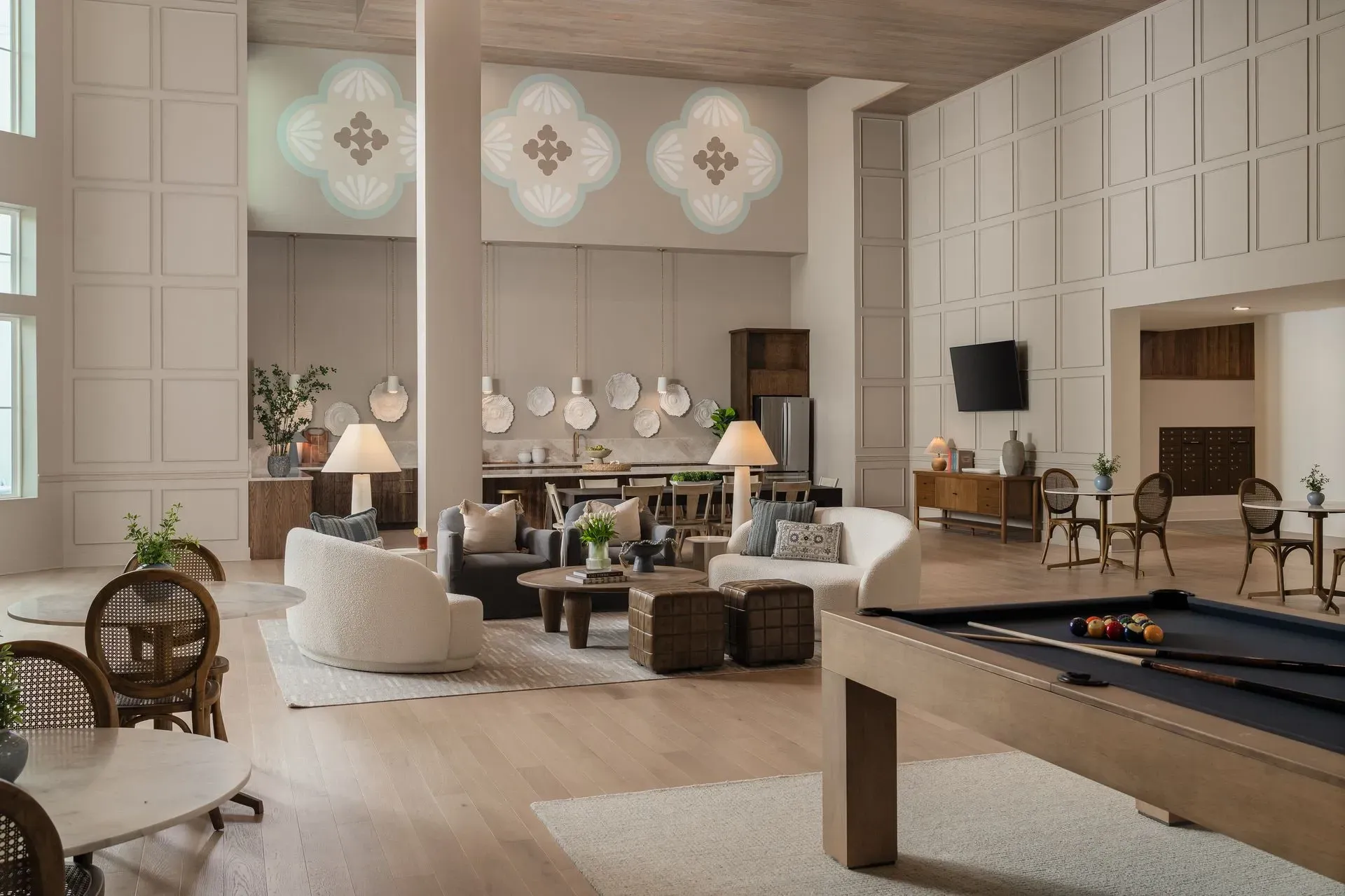 Common area with a pool table, seating, and kitchen.