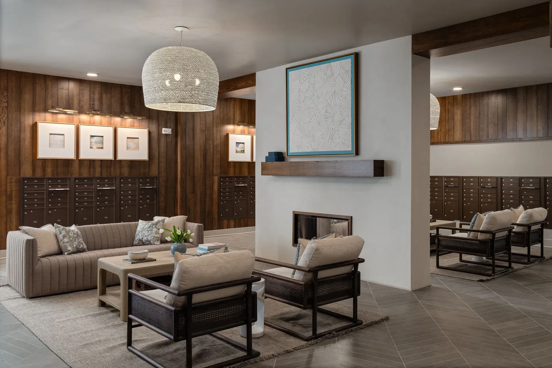 Lobby area with mailboxes, seating, and fireplace.