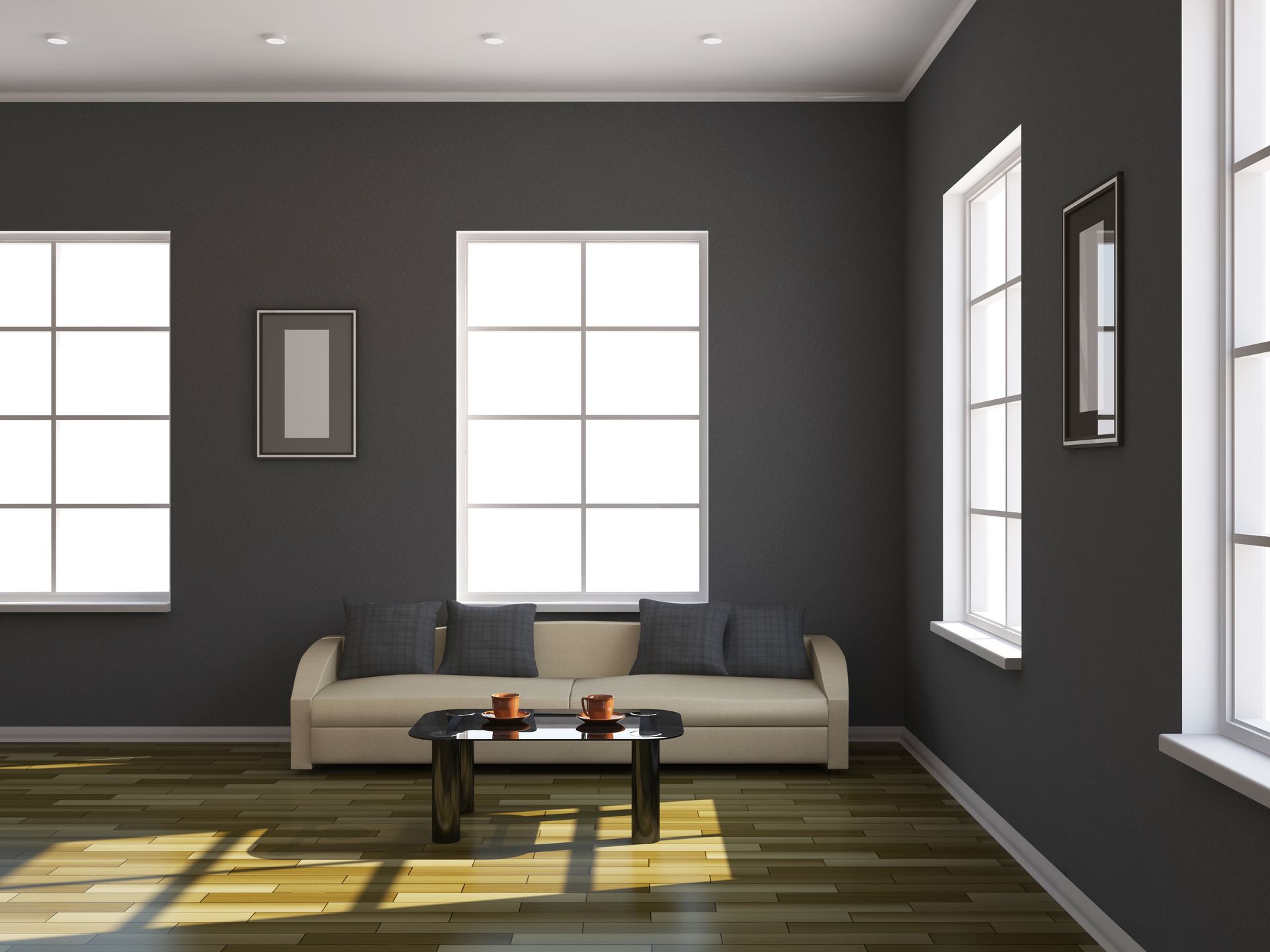 Modern living room with dark gray walls, beige sofa, coffee table, and sunlight through large windows