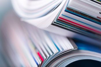A close up of a stack of magazines on top of each other A close up of a stack of magazines on top of each other