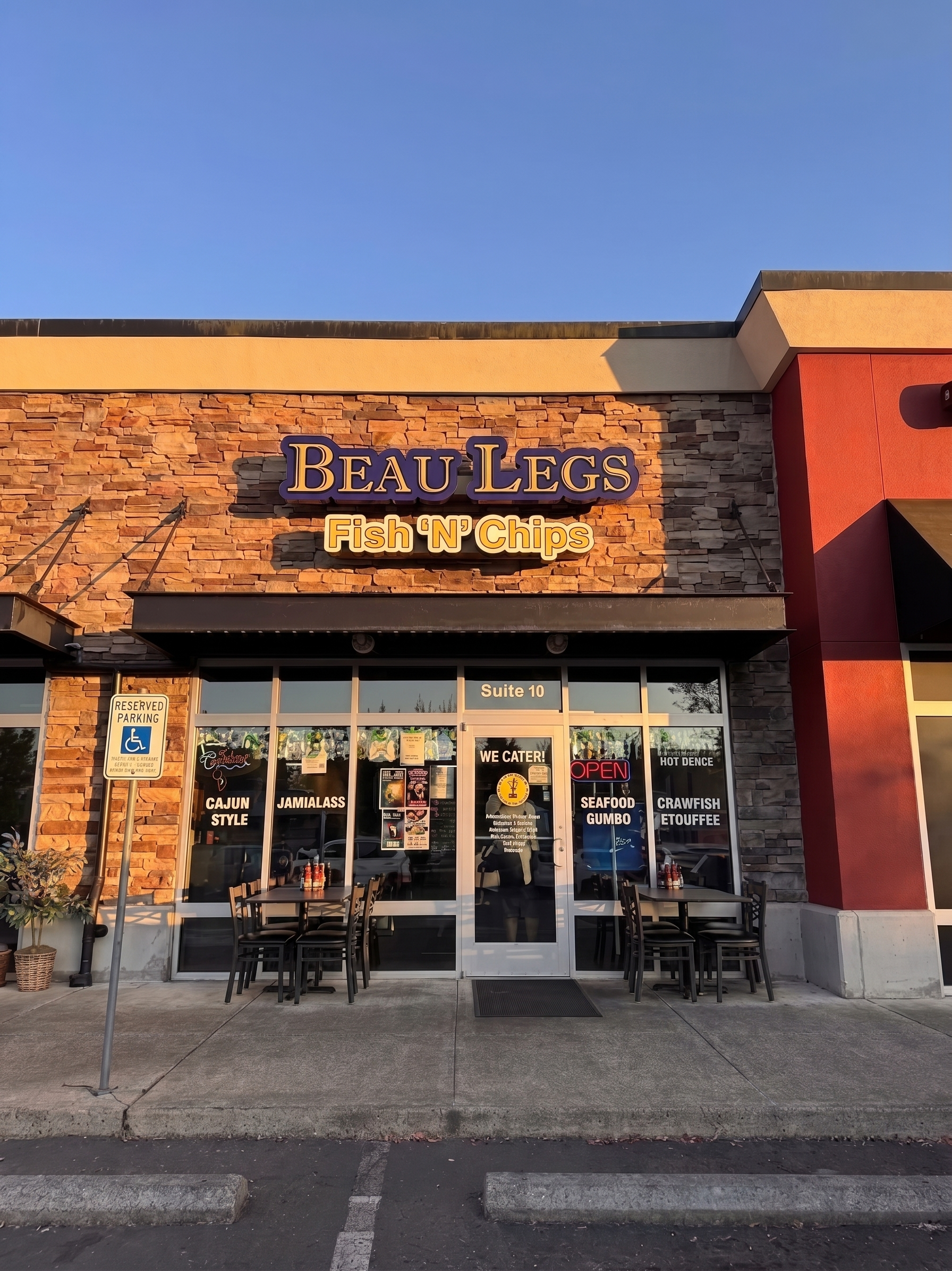 Beau’s Fish Wings storefront with orange brick facade and glass entrance at sunset