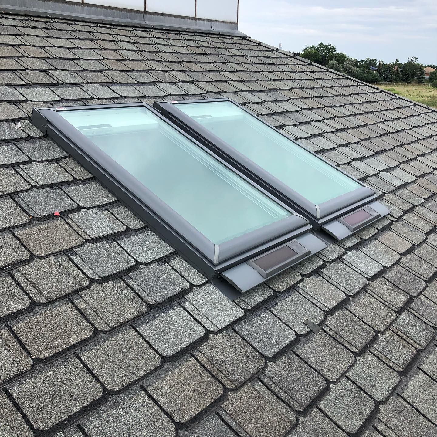 Two skylights are sitting on top of a roof