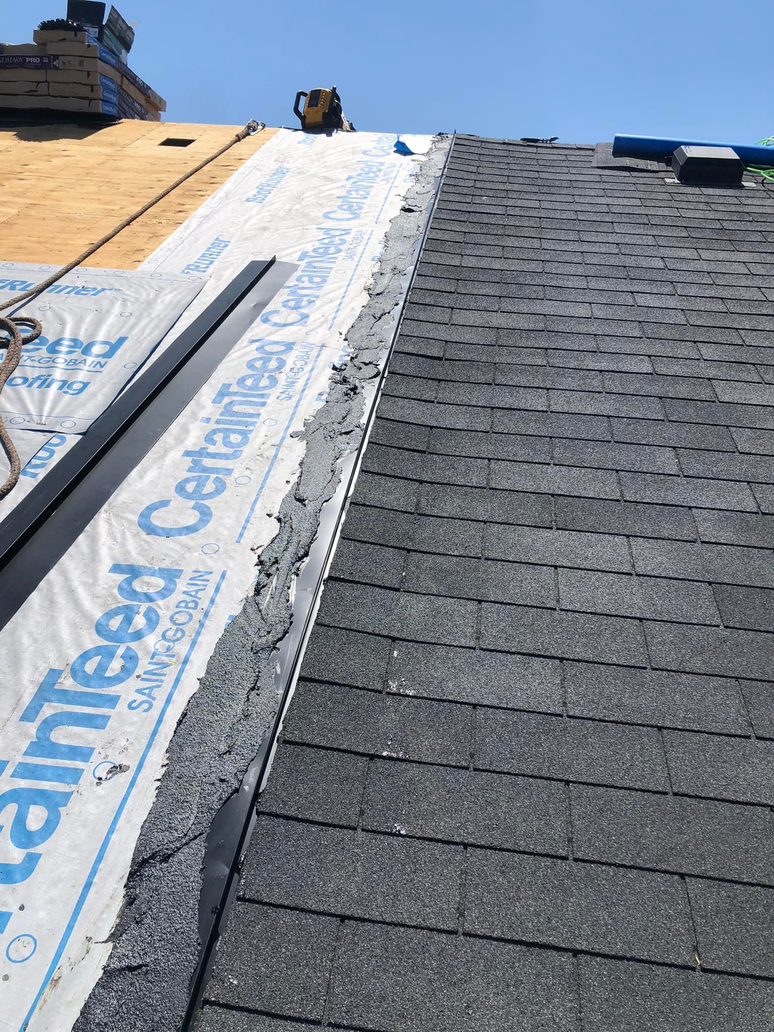 A close up of a roof with shingles being installed on it
