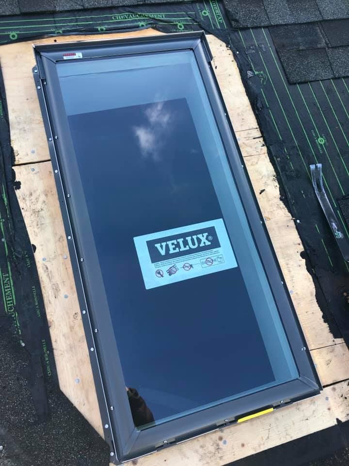 A velux skylight is sitting on top of a roof