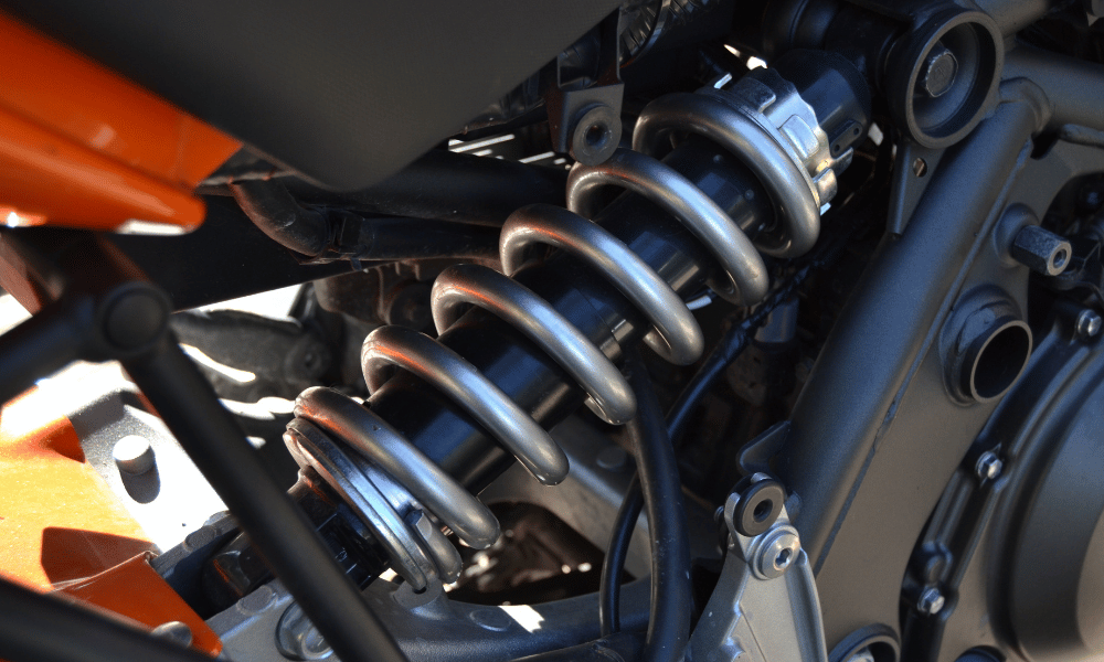 Close-up of vehicle suspension coil and shock absorber