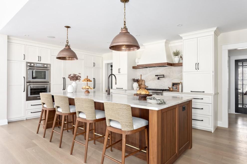 A kitchen with white cabinets and a large island in the middle