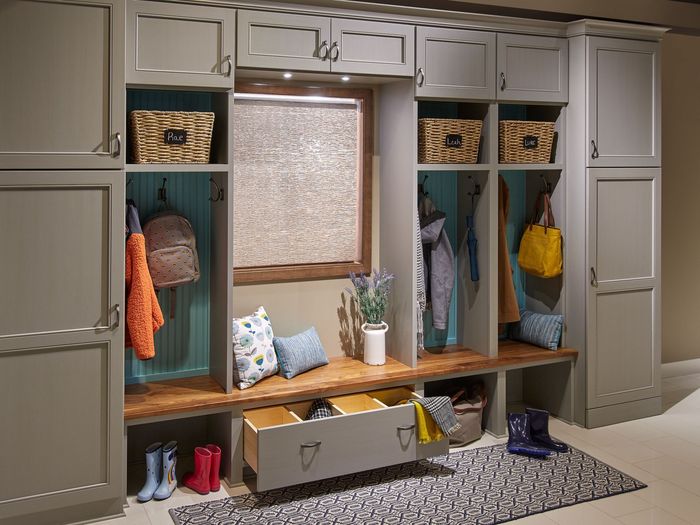 A mud room with lots of cabinets and drawers and a bench.