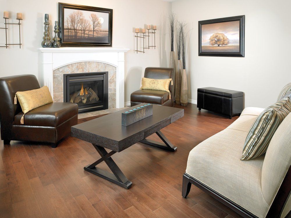 A living room with a fireplace couch and chairs