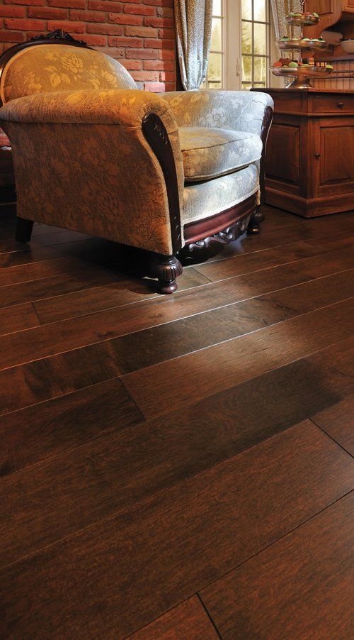 A chair is sitting on a wooden floor in a living room.