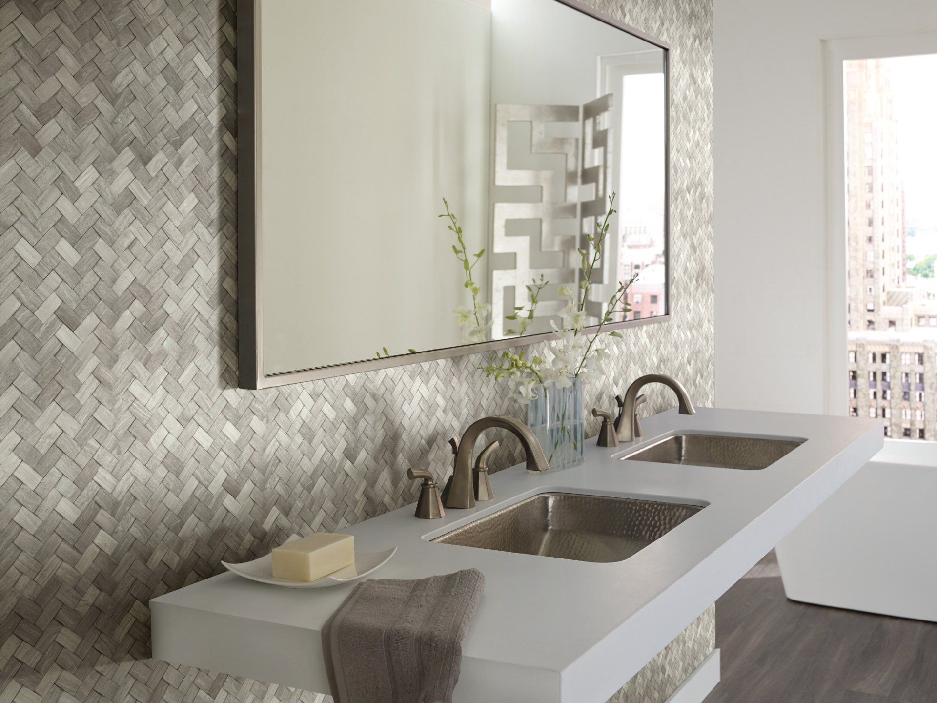 A bathroom with two sinks and a large mirror