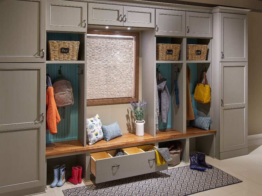 A mud room with lots of cabinets and drawers and a bench.