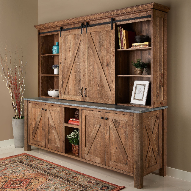 A wooden cabinet with sliding barn doors and shelves
