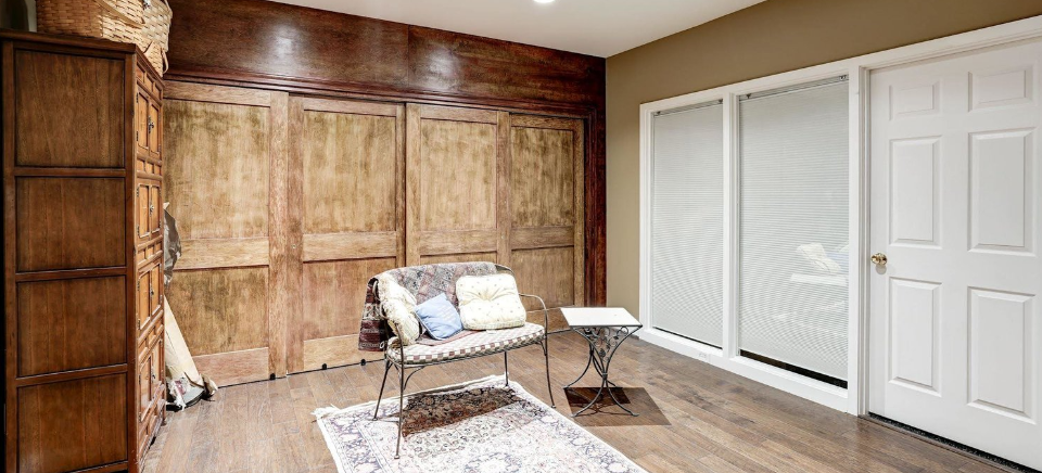 A living room with hardwood floors , a couch , and a rug.