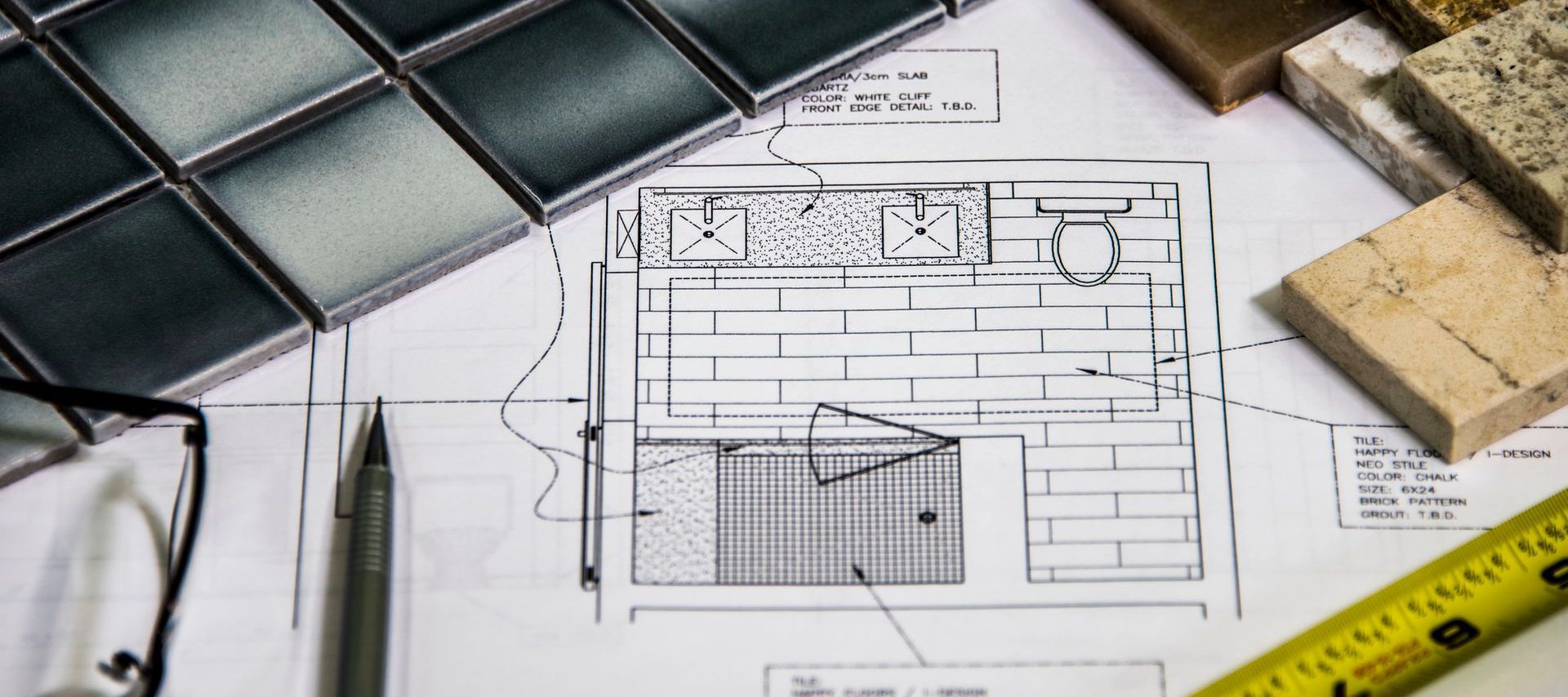 A drawing of a bathroom with tiles and a ruler on a table.